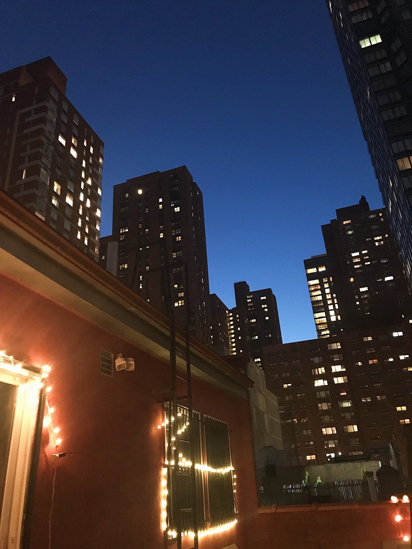 New York buildings against a deep blue evening sky